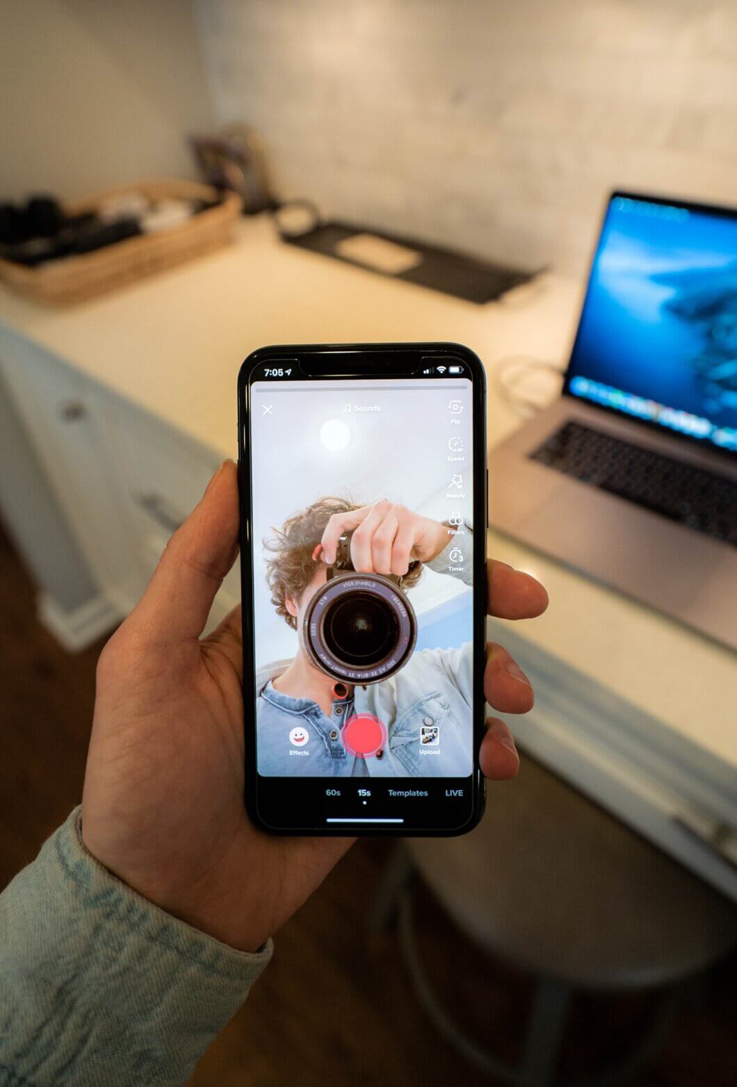 Creator filming vertical video content for a TikTok ads strategy campaign